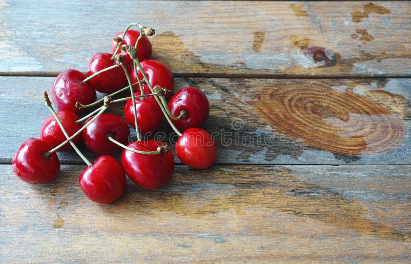 Fresh red cherries against wooden background. Fresh red cherries against wooden background.