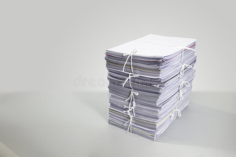 Pile or heap of financial business document paperwork stack on office desk concept of workload overtime or workplace paperless copy