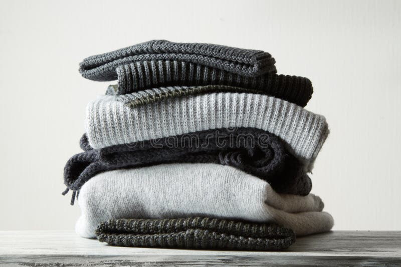 Pile of knitted winter clothes on background, sweaters, knitwear,. Winter woolen clothes stock images, royalty-free photos and pictures