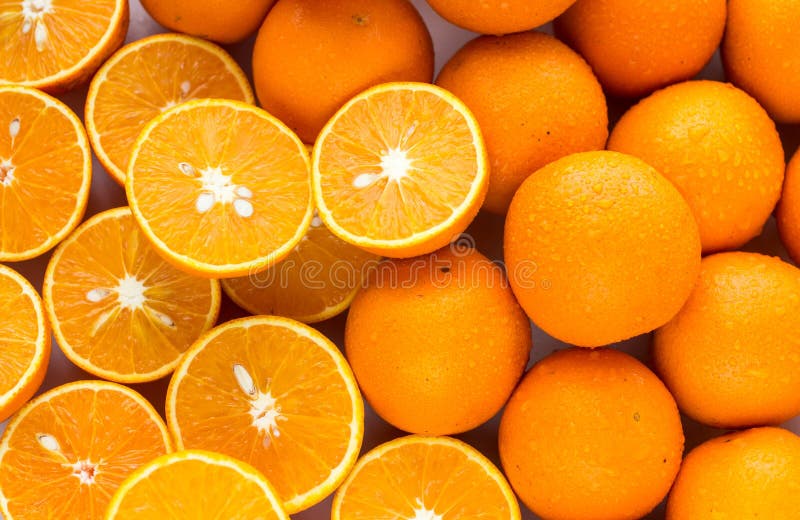 Pile of Oranges Sliced and Whole Stock Photo Image of yellow, closeup 64332434