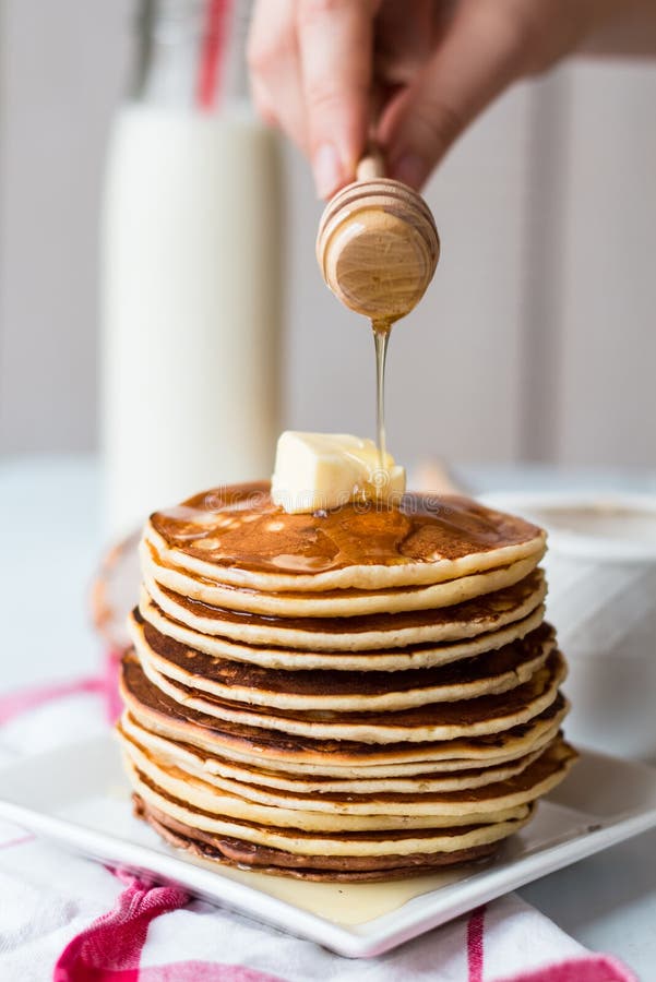 Pile Of Pancake With Butter, Honey Sauce Add, Hands Stock