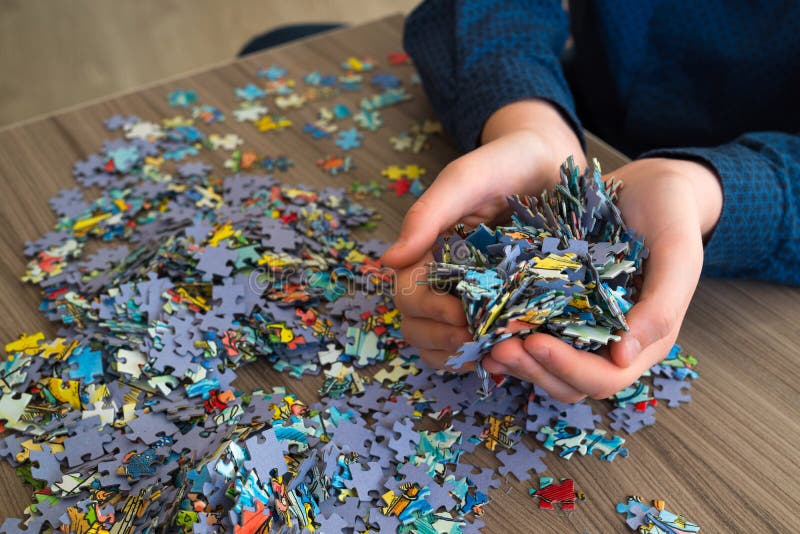 Handful of puzzles in hands of a teenager