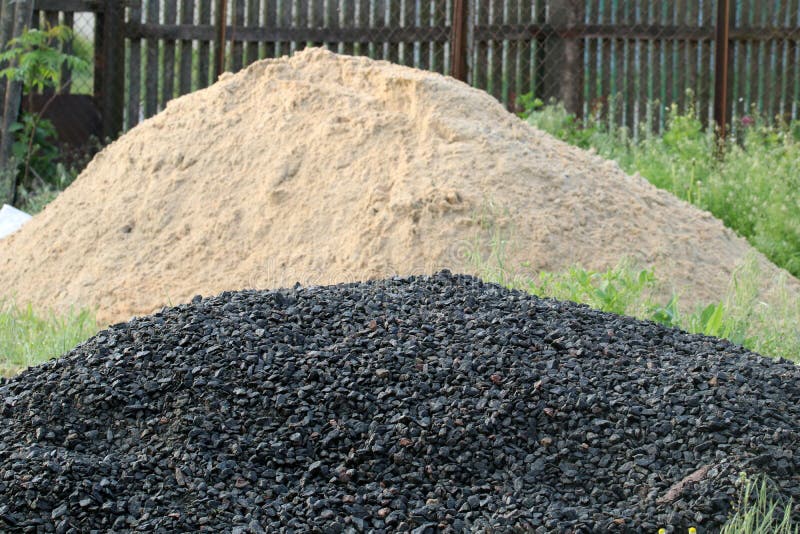 A Pile of Rubble for Making Concrete. a Pile of Sand for Making