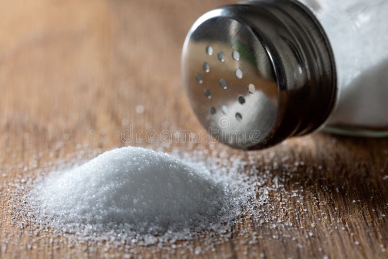 Pile of salt and one salt shaker royalty free stock images