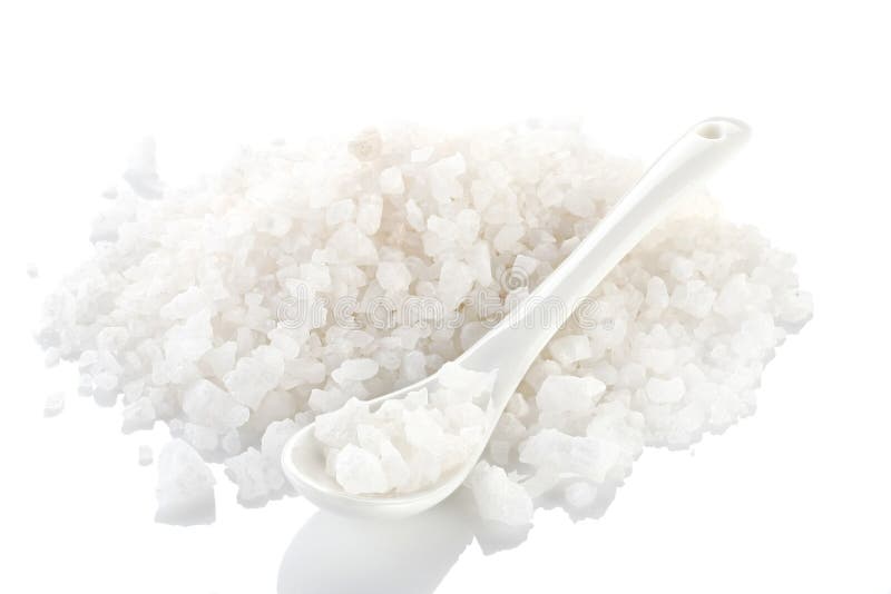 A pile of sea salt with a ceramic spoon on a white background. i royalty free stock image A pile of sea salt with a ceramic spoon on a white background. i royalty free stock image