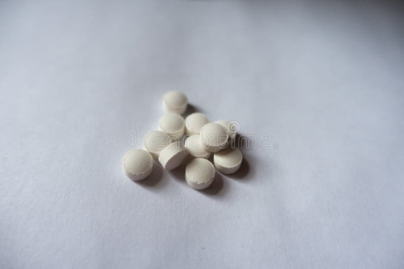 Pile of small white vitamin k tablets stock images Pile of small white vitamin k tablets stock images