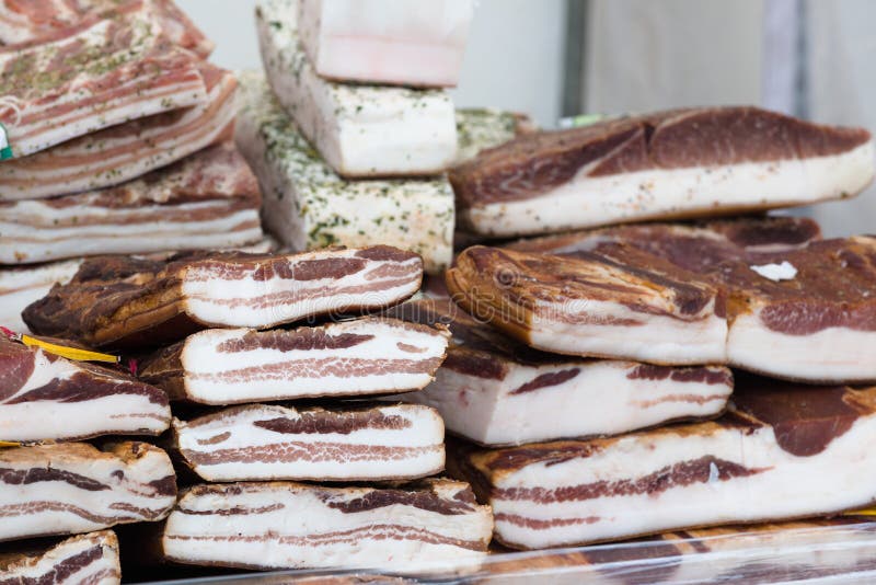 Smoked bacon flitch for sale at a local farmer`s market in Lithuania