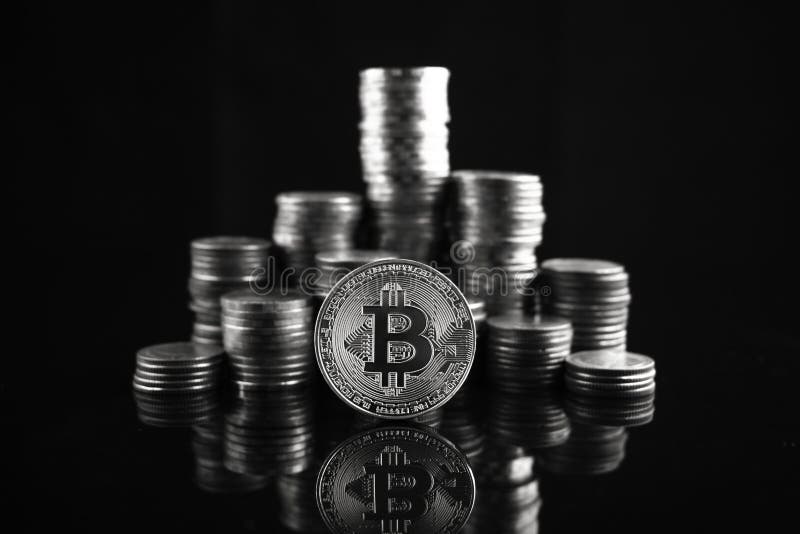 Pile of stacking coins with silver bitcoin on top, king of all coins, most valuable coin, rising currency concept