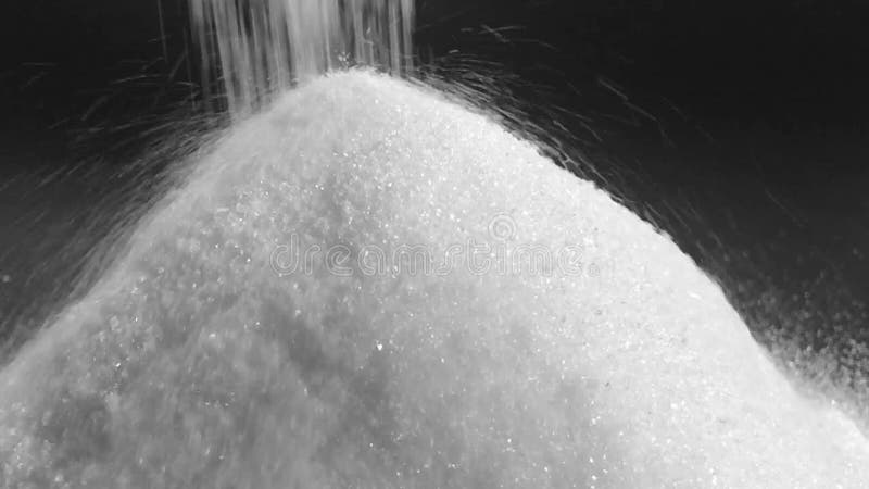 Pile of sugar on black background