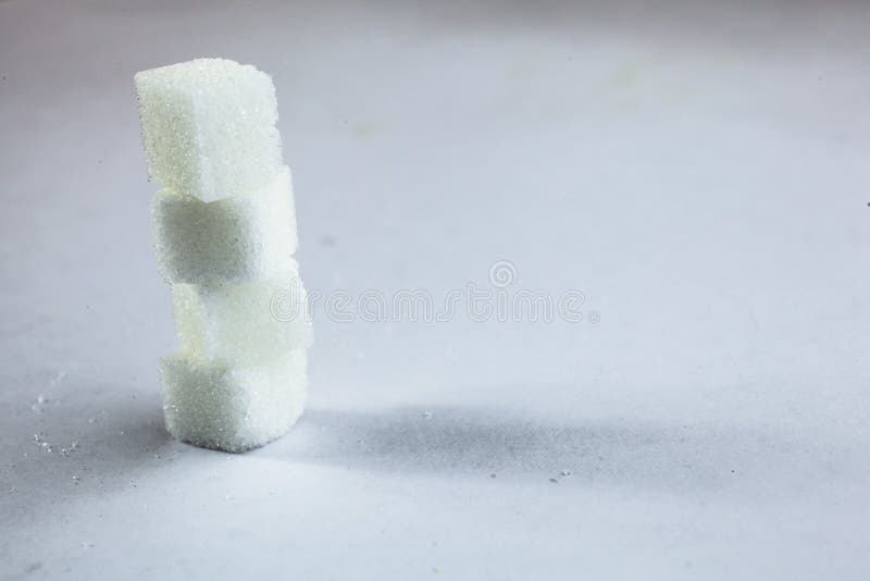 Pile of Sugar Cubes Stacking on Isolated White Background with Harsh Shadow, which can be used to imply dark side of Sugar. royalty free stock photos
