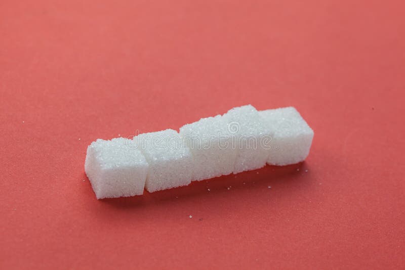 Pile of Sugar Cubes Stacking on red background stock photos