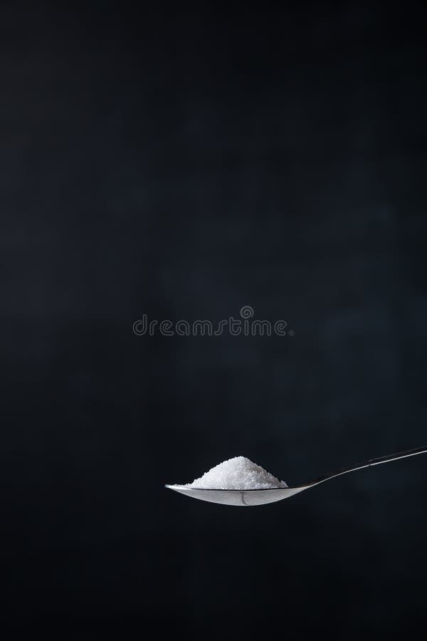 Pile of sugar on a teaspoon