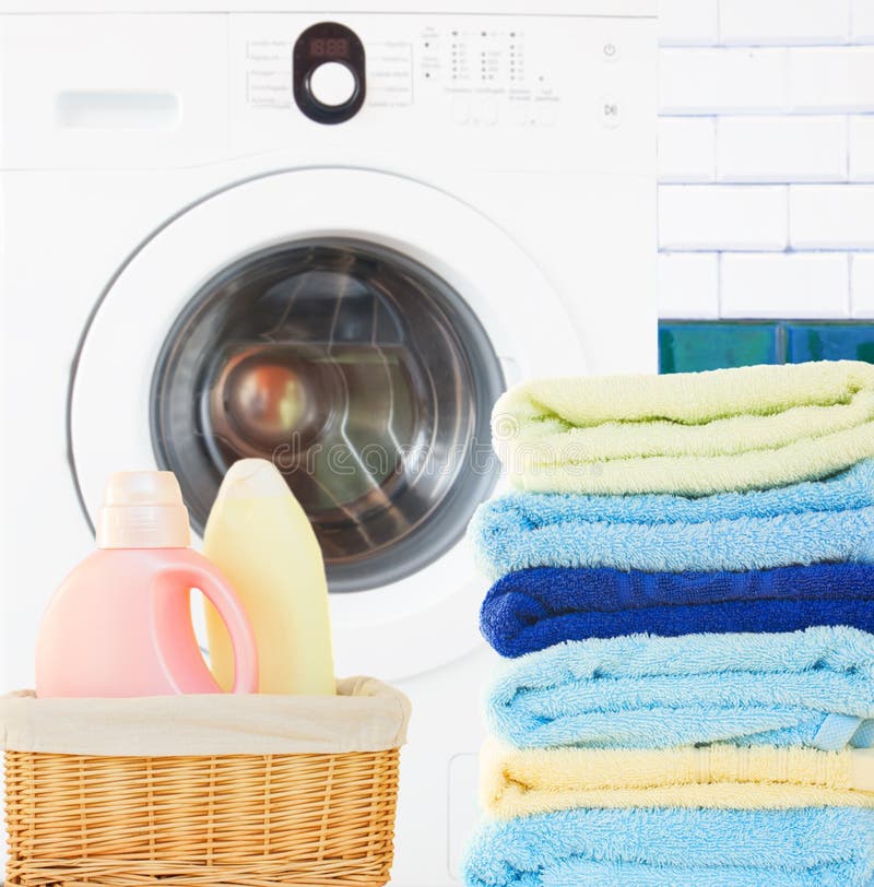 Pile of Towels with detergent and washing machine