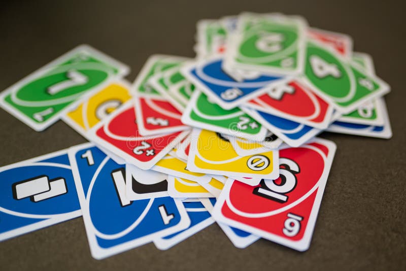 Deck of Uno Game Cards Scattered All Over on a Table. American