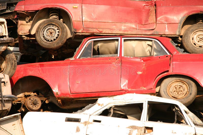 Pile of used cars in junkyard, ready for salvage