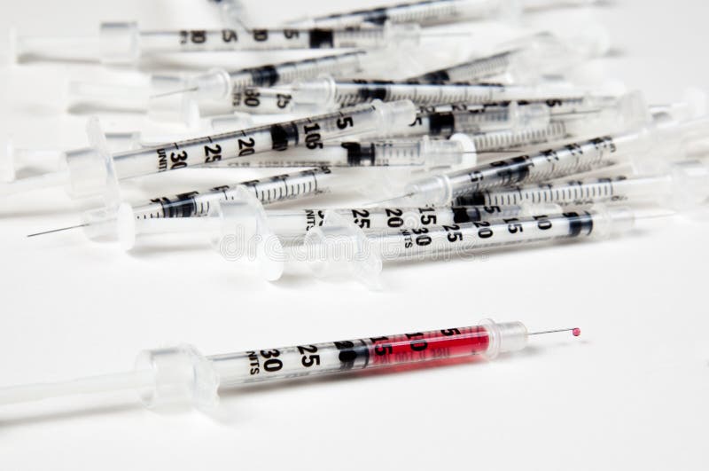 Pile Of Used Syringes With A Single Filled One Stock Photos Image