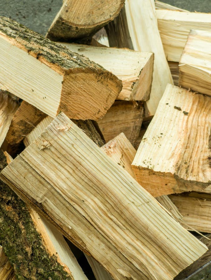 A pile of wood sitting on top of a pile of logs royalty free stock photo