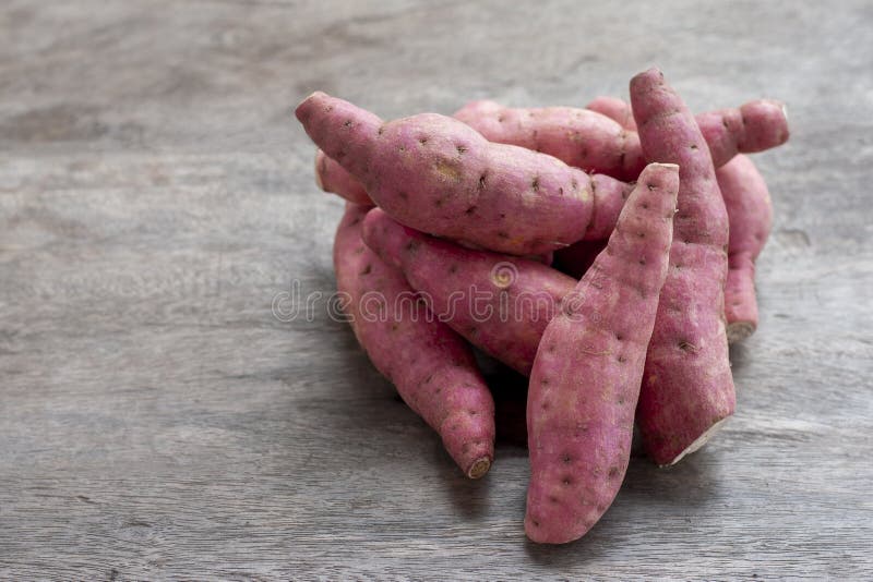 Pile of Yam or Sweet potato on wooden table. royalty free stock images Pile of Yam or Sweet potato on wooden table. royalty free stock images