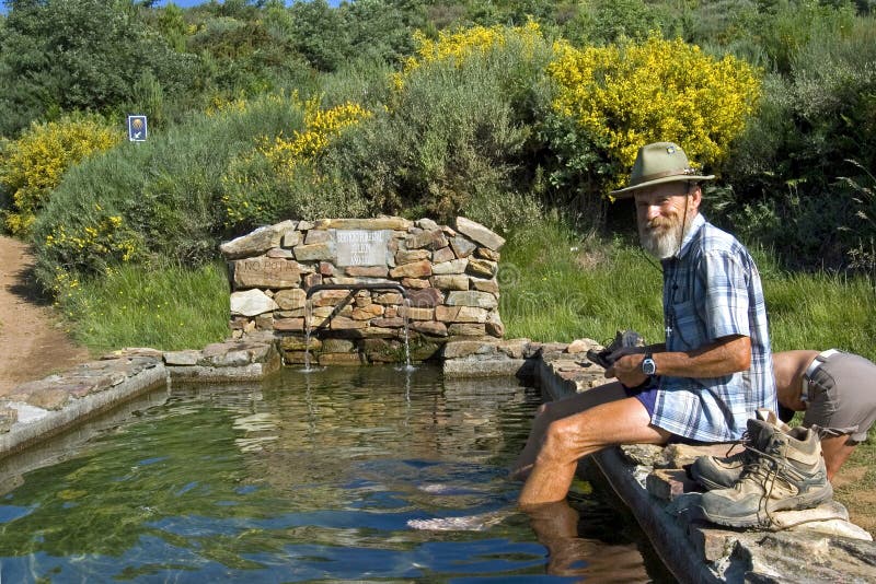 Pilgrim takes footbath in water basin royalty free stock images