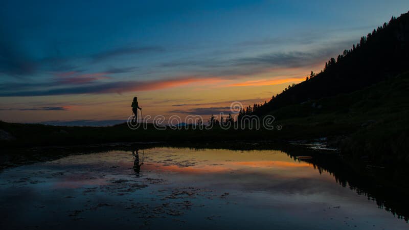 Pilgrimage in solitary at sunset near a lake with fairy tale col