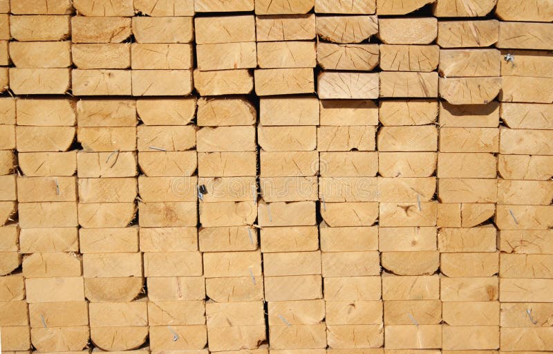 A pile of 2 by 4 wooden planks at a construction site. A pile of 2 by 4 wooden planks at a construction site.