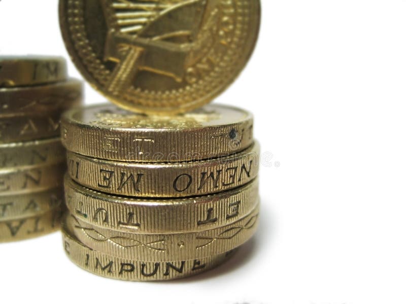 Two stacks of pound coins, shallow depth of field. Two stacks of pound coins, shallow depth of field