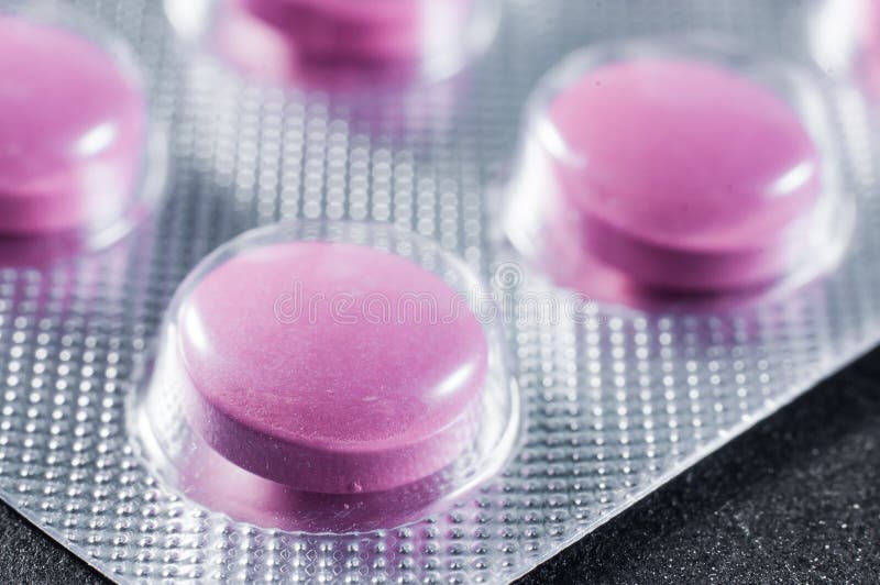 Pillole rosa in un bastone medico di plastica immagine stock Pillole rosa in un bastone medico di plastica immagine stock