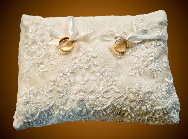 Pillow with wedding rings stock photo. Image of golden 19526020