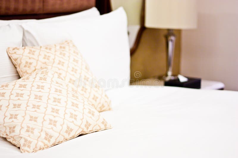 Pillows in Hotel bedroom stock image. Image of retreat 25809181