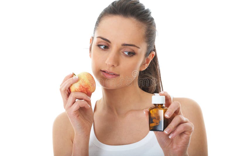 Pills or apple, two sources of vitamins, isolated