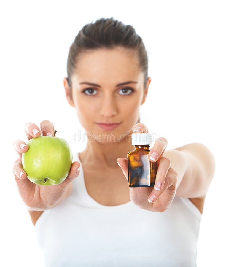 Pills or apple, two sources of vitamins, isolated