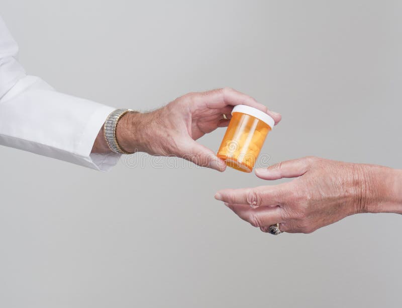 Pills being passed to patient by doctor