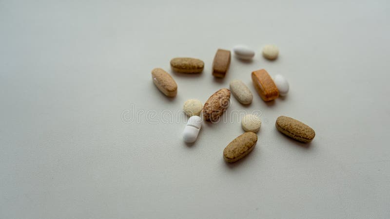 Pills mixed with coin on a light background. Medical concept. stock image Pills mixed with coin on a light background. Medical concept. stock image