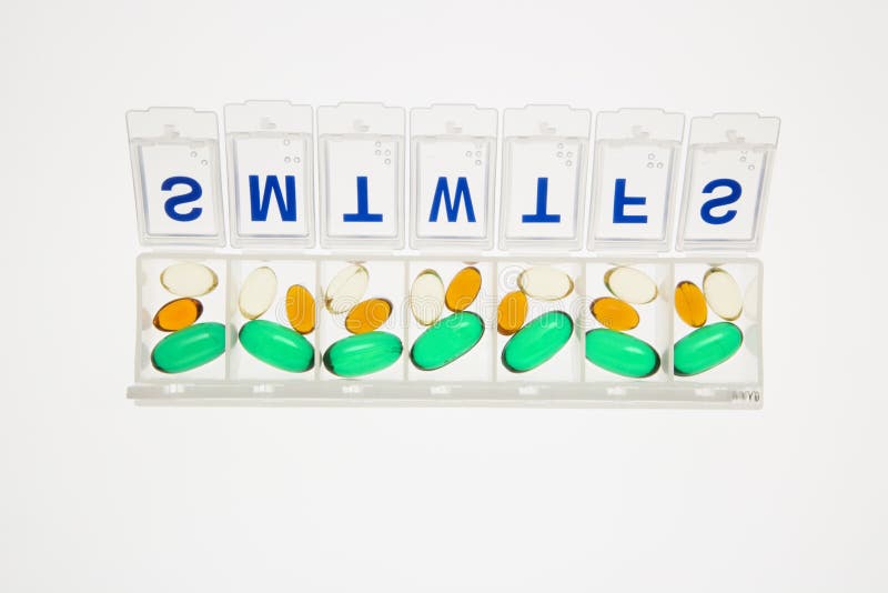 Pills in Open Pill Organizer. Isolated