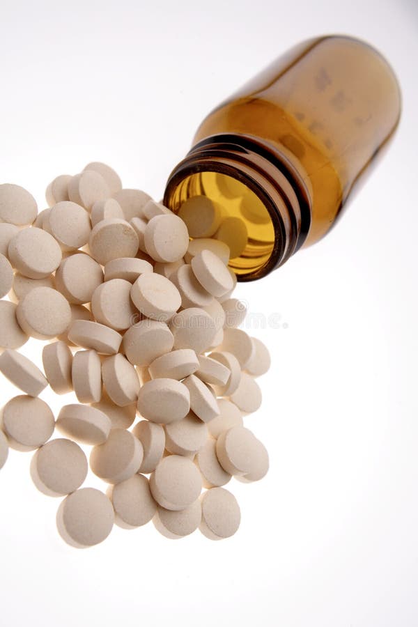Pills spilling from bottle stock photo. Image of care 3629008
