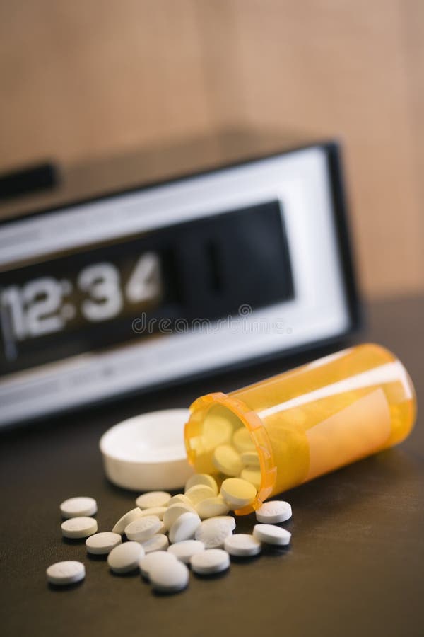 Pills spilling out of medicine bottle. royalty free stock photography