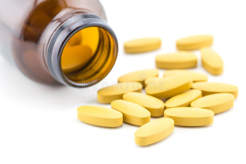 Pills of vitamin C spilled out open container stock photo Pills of vitamin C spilled out open container stock photo