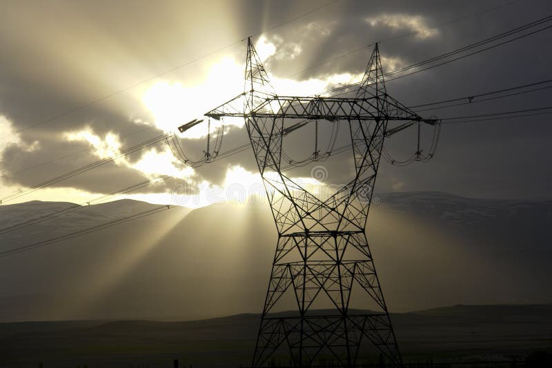 A high voltage electricity distribution pylon with a sunset background. A high voltage electricity distribution pylon with a sunset background.