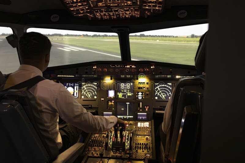 Pilot and Copilot in Aircraft Simulator with Controls royalty free stock photo