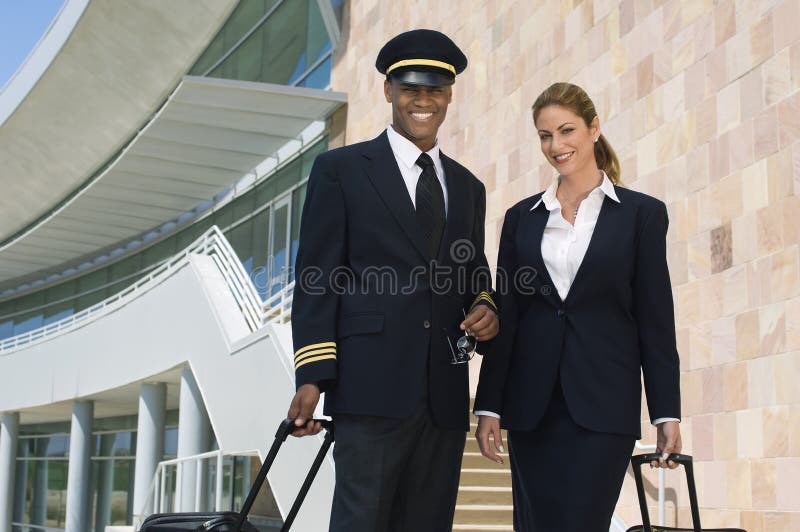 Pilot And Flight Attendant Outside Building royalty free stock photography