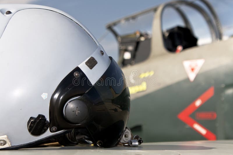 Pilot's helmet and jet aircraft royalty free stock photo