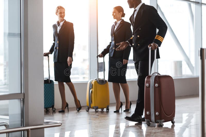 Pilot and Stewardesses with Luggage Walking Stock Photo Image of