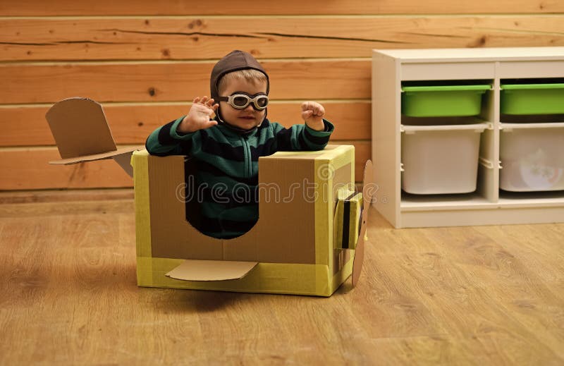 Pilot travel. Little boy child play in cardboard plane, childhood. stock photography Pilot travel. Little boy child play in cardboard plane, childhood. stock photography