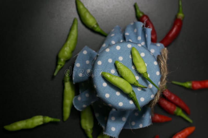 Pimienta de chile en tela azul del punto y fondo negro foto de archivo Pimienta de chile en tela azul del punto y fondo negro foto de archivo