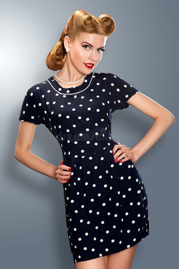 Pin-up girl in retro vintage dress posing