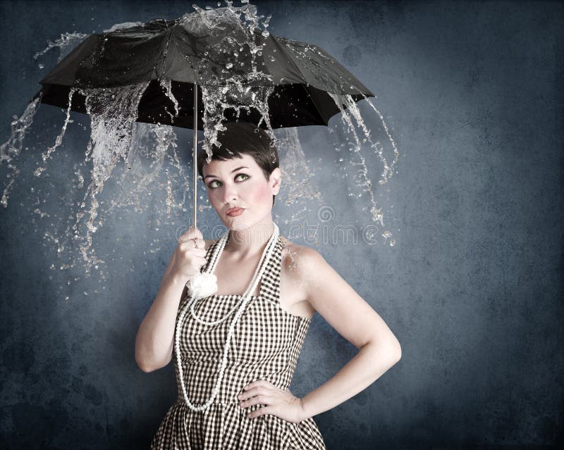 Pin-up girl with umbrella under water splash