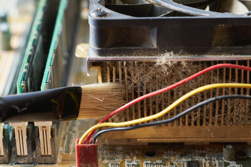 Cleaning dirty desktop computer processor fan from dust by special brush close up. Cleaning dirty desktop computer processor fan from dust by special brush close up.