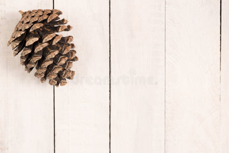 Pine cone on white rustic desk. Christmas theme. Flatlay. Space for text. stock photos Pine cone on white rustic desk. Christmas theme. Flatlay. Space for text. stock photos