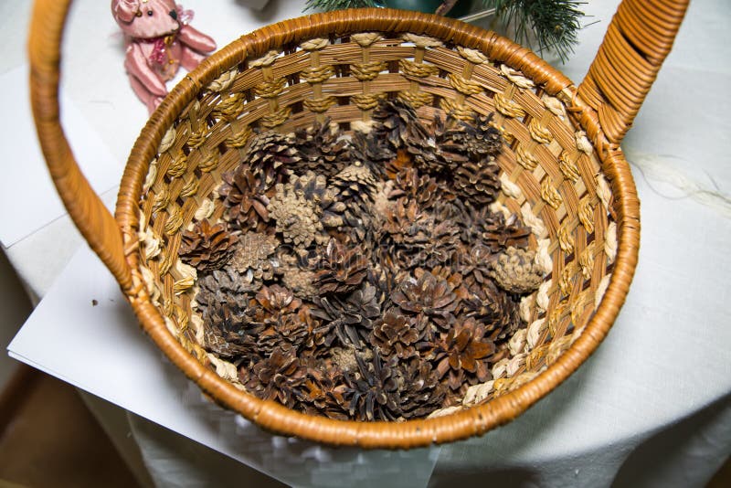 Pine cones in a round wicker basket with a handle. Holidays, Christmas, New year royalty free stock image Pine cones in a round wicker basket with a handle. Holidays, Christmas, New year royalty free stock image