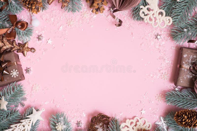 Pine tree branches and Christmas decoration on colored background with copy space. New Year Xmas greeting card stock image